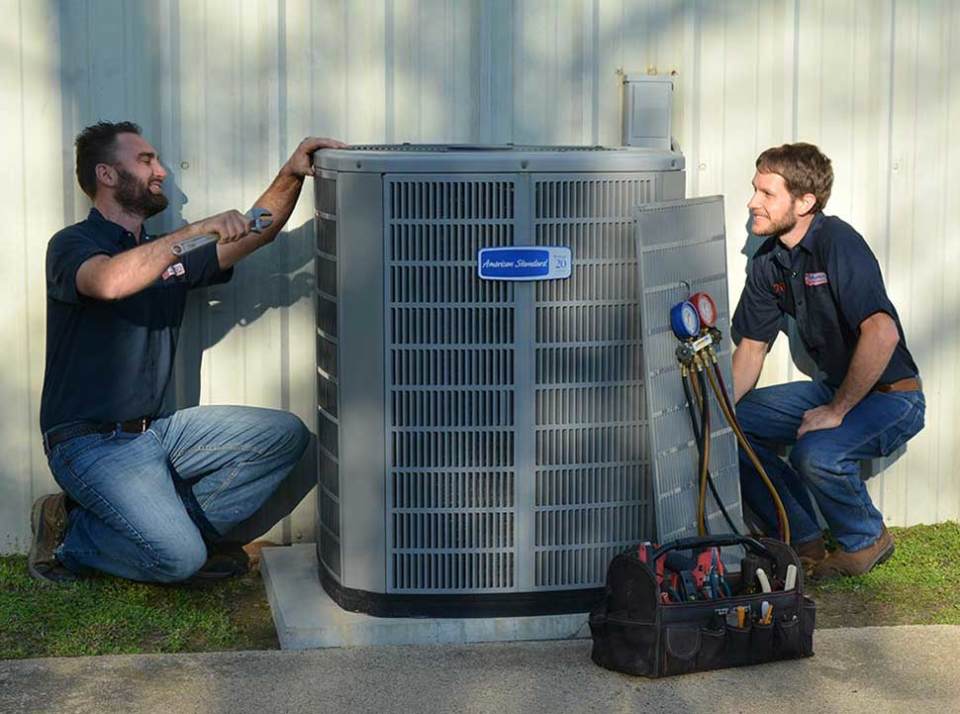 Our highly trained technicians working on an HVAC unit